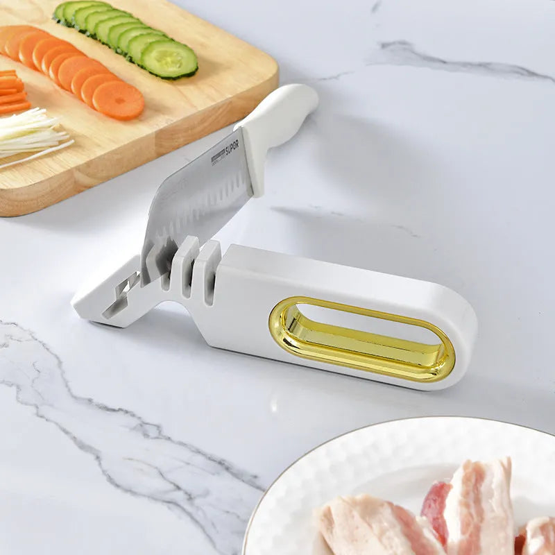 Four-in-one stone manual grinder for sharpening kitchen knives in pearl white colour, with ceramic and diamond stages visible