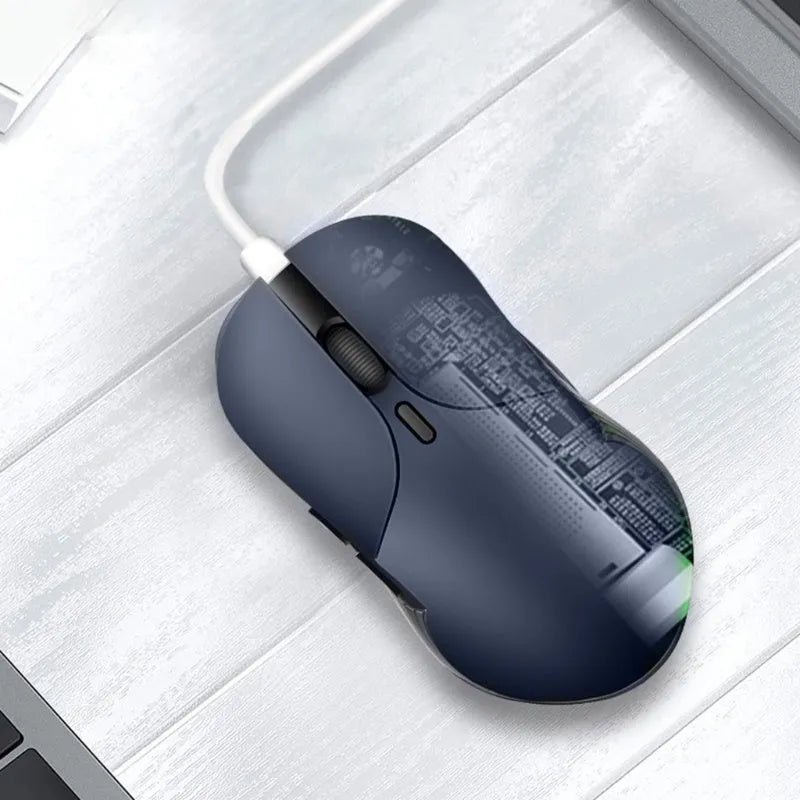 Blue rechargeable wireless voice translator mouse on a desk next to a laptop.
