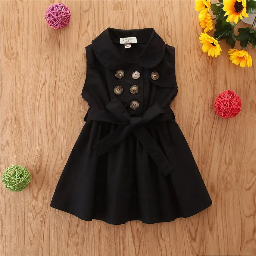 Baby girl in a sleeveless cotton A-line princess dress with a sash and button detail.