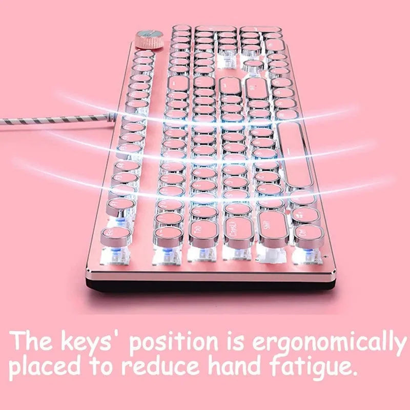 Pink and silver wired mechanical keyboard with green switches and matching mouse on a desk.