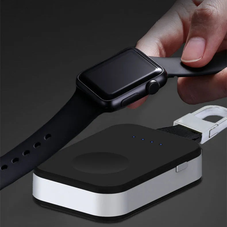 Black portable wireless power bank charger for Apple Watch on a keychain.