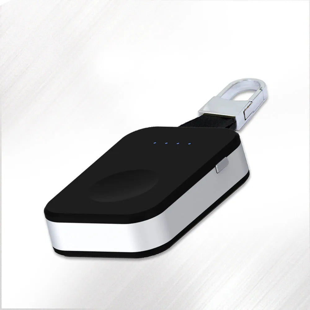 Black portable wireless power bank charger for Apple Watch on a keychain.