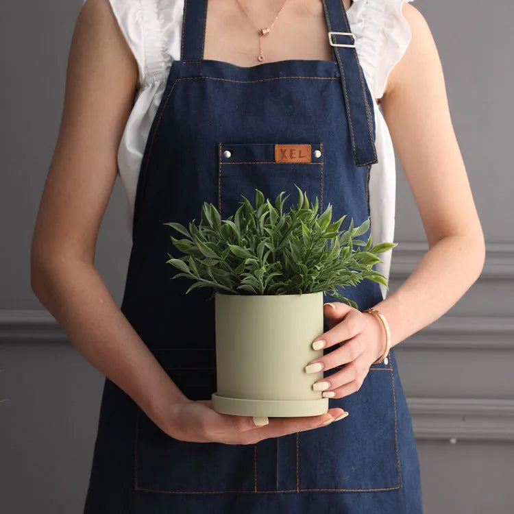 Cylindrical ceramic succulent planter with drainage hole in Nordic style, shown in a selected colour.