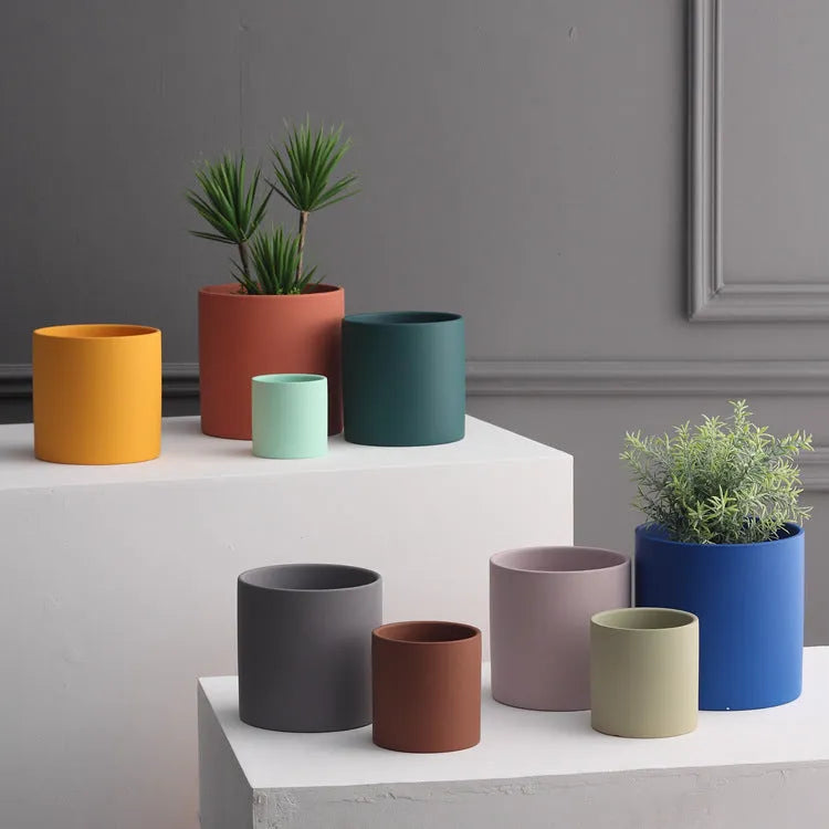 Cylindrical ceramic succulent planter with drainage hole in Nordic style, shown in a selected colour.
