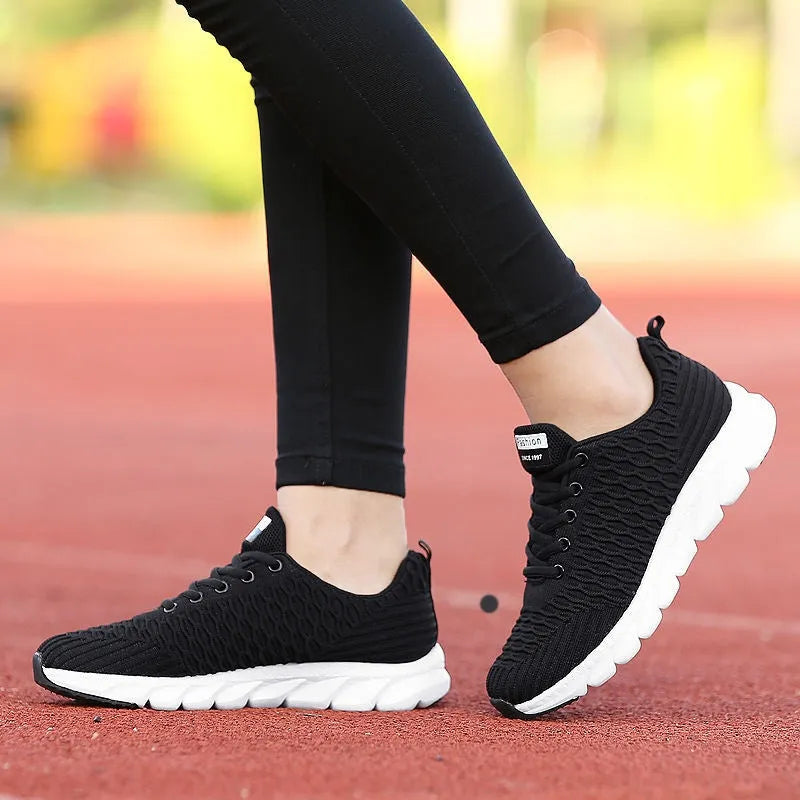 Women's running shoes with fly weaving upper in black, pink, or white colours showing wear-resistant outsole