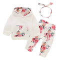 White print hooded romper suit for baby girls made from soft cotton with long sleeves and trousers.