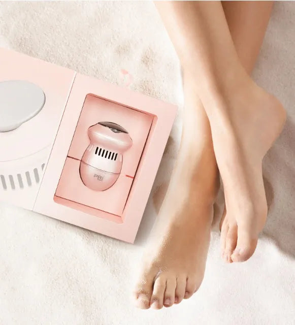 Beige and white electric foot file grinder with USB cable and two diamond grinding heads on a plain background