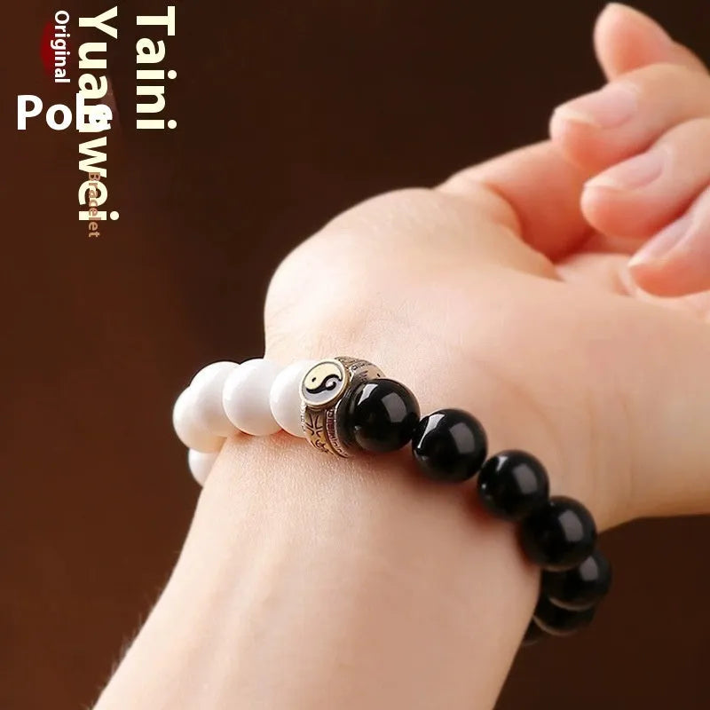 Black obsidian Taiji bracelet with white woven yin-yang symbol and mantra.