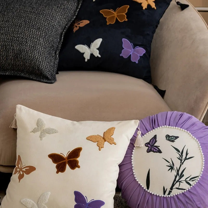 Square beige cushion with detailed Chinese butterfly embroidery design.