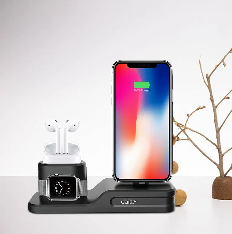 Black silicone 3-in-1 charging base for Apple-compatible iPhone, iWatch and AirPods devices on flat surface