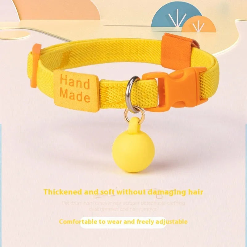A simple, solid-colour elastic pet collar for small dogs, laid flat on a surface.