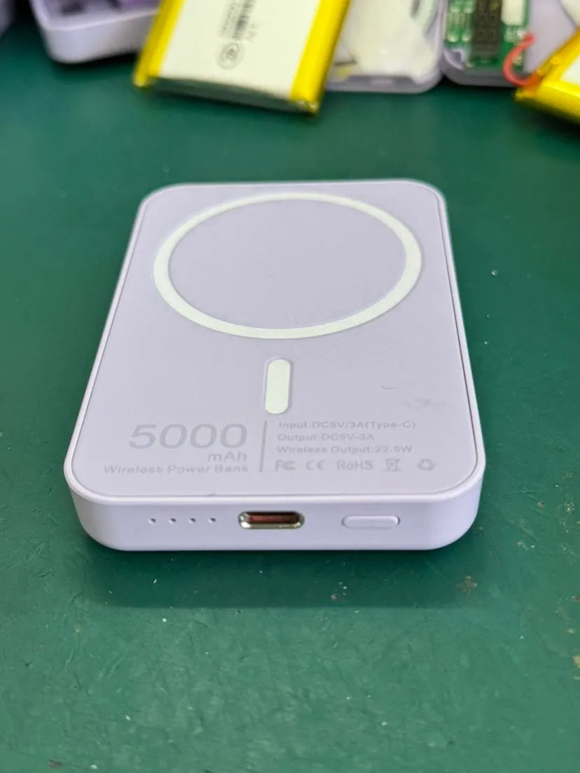 White foot-shaped portable power bank with magnetic wireless charger on a table.