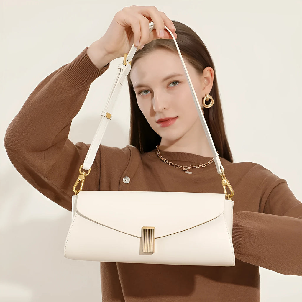 Cowhide leather women's cross-body bag in a clamshell, pillow-shaped design.
