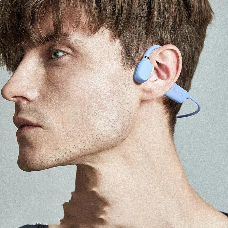 A person wearing bone conduction Bluetooth headphones with a wireless neckband sensor during a run.