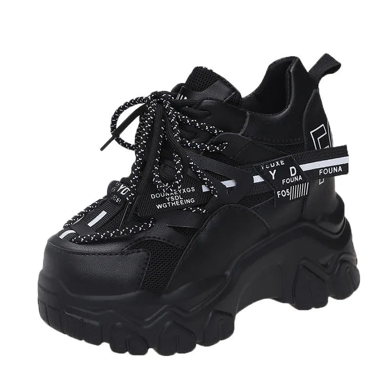 Women's white and black platform tennis shoes with mesh upper and cross-strap.