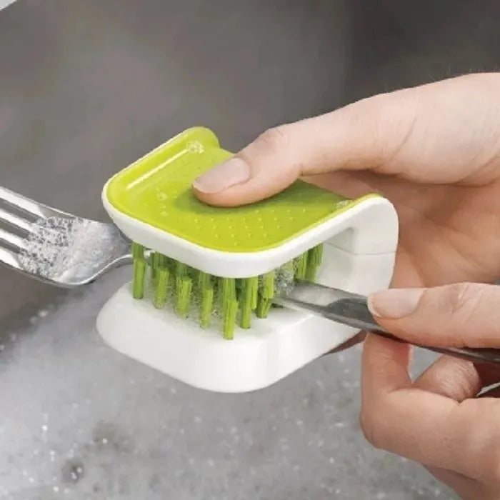 Blue U-shaped plastic brush with bristles for cleaning knives and cutlery in a kitchen.
