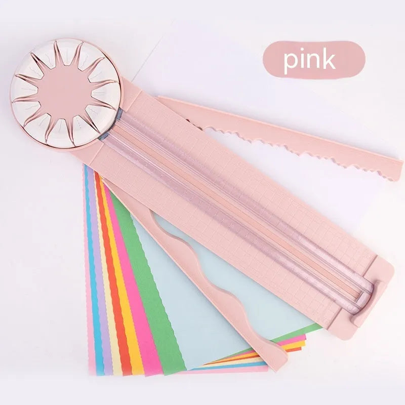 Pink plastic 12-in-1 multifunctional paper cutting machine for crafts on a white background.