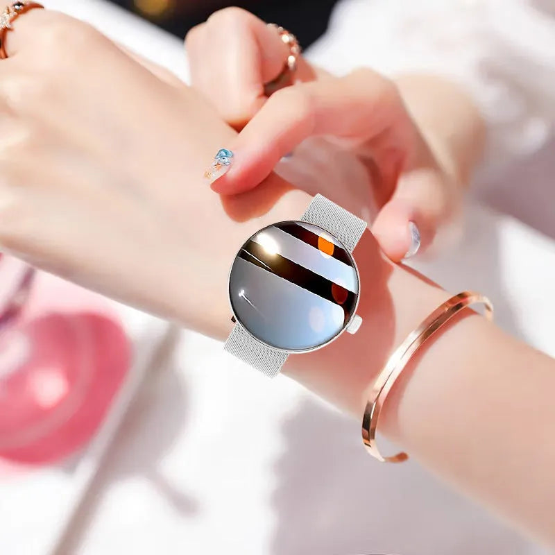 Women's smart watch with circular colour screen and metal strap on wrist