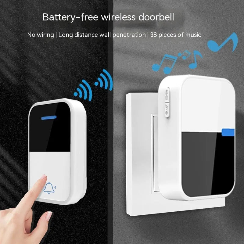 Modern white plastic wireless doorbell receiver and self-generating push-button transmitter on a table.