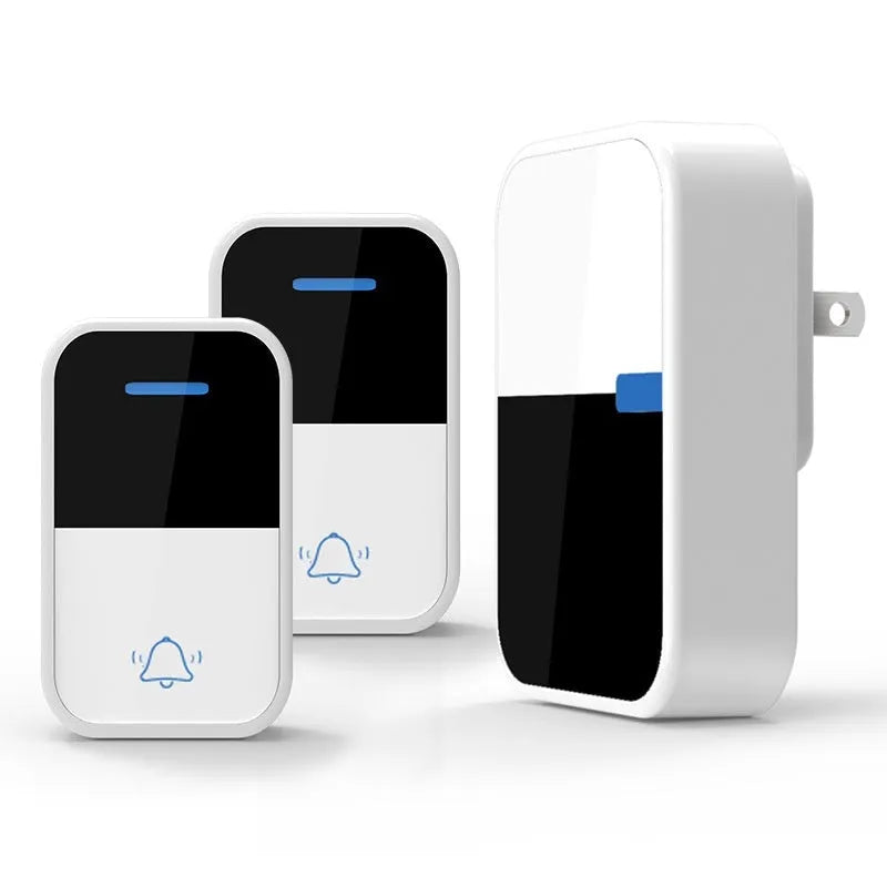 Modern white plastic wireless doorbell receiver and self-generating push-button transmitter on a table.