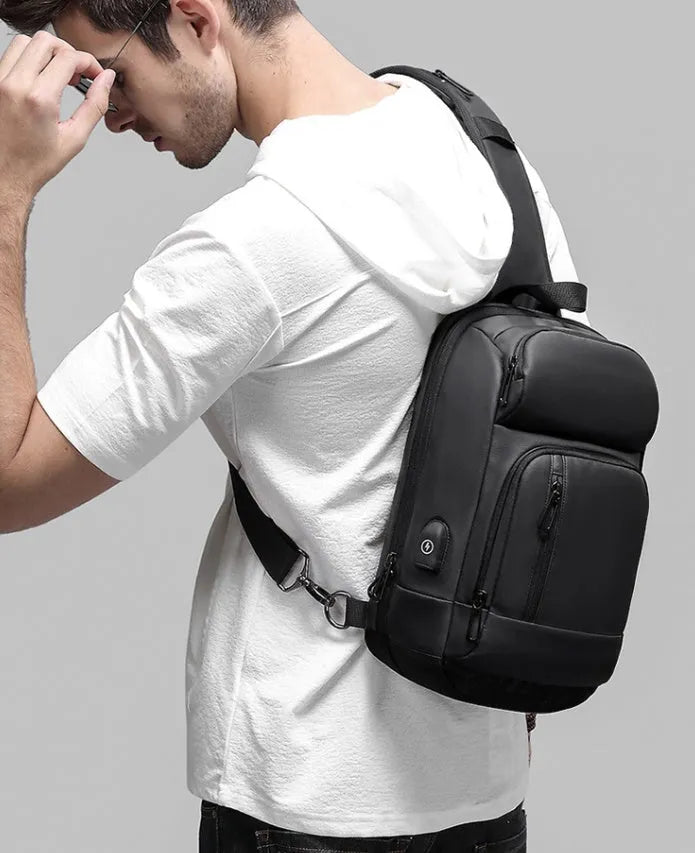 Black medium outdoor shoulder bag with air cushion strap showing internal laptop and organiser pockets