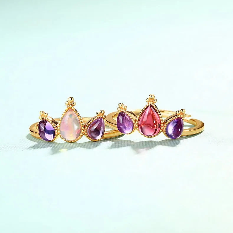 Sterling silver ring with drop-shaped garnet stone on finger, 925 silver, electroplated finish