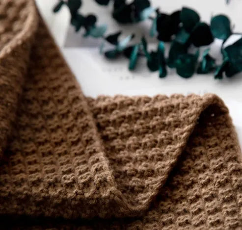 Nordic fringed knit ball acrylic blanket in beige colour, measuring 130 by 170 centimetres.