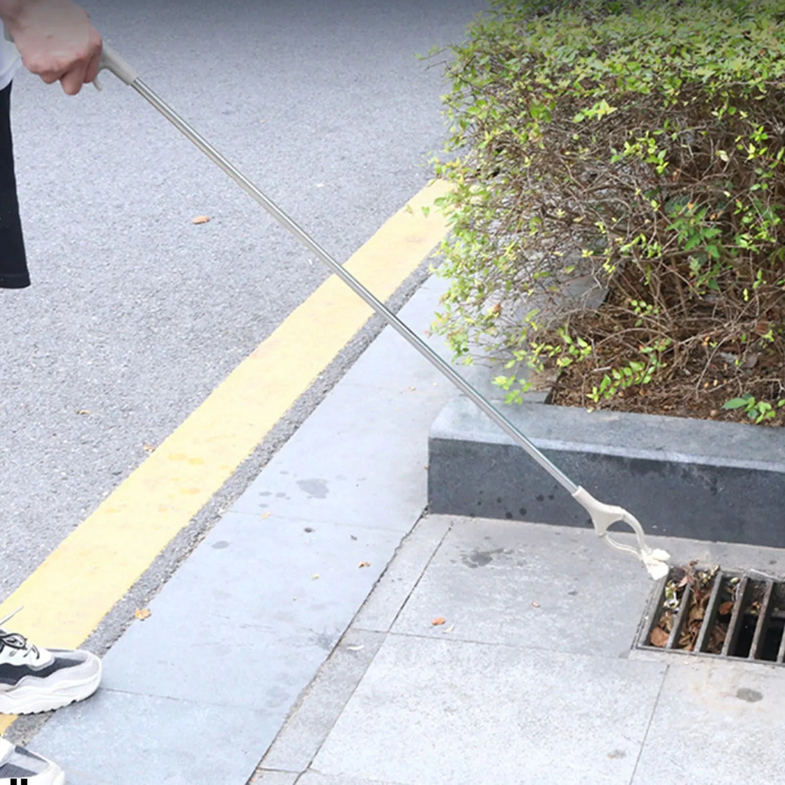 40cm long stainless steel and plastic garbage picker tool with push-type handle.