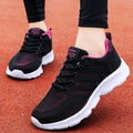 Women's white mesh breathable leisure jogging shoes with front lace-up.