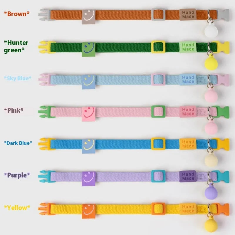 A simple, solid-colour elastic pet collar for small dogs, laid flat on a surface.
