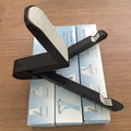 Black foldable tablet holder showing adjustable angles and rubber surface for device protection