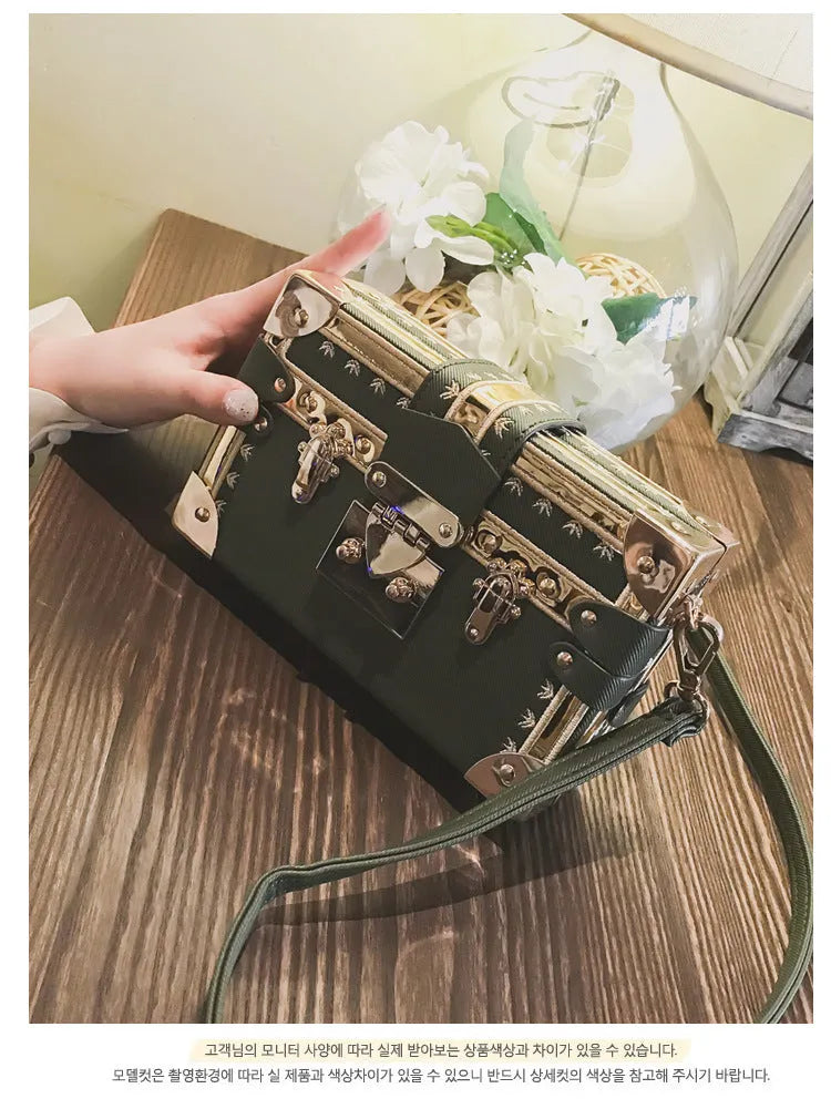 Hard black PU leather women's crossbody flap bag with metal rivet detail and hasp closure.