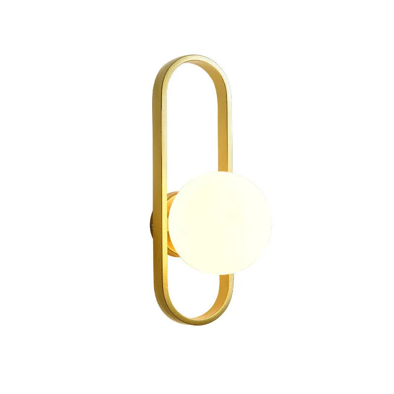 Minimalist black iron wall lamp with a glass shade mounted on a white wall.