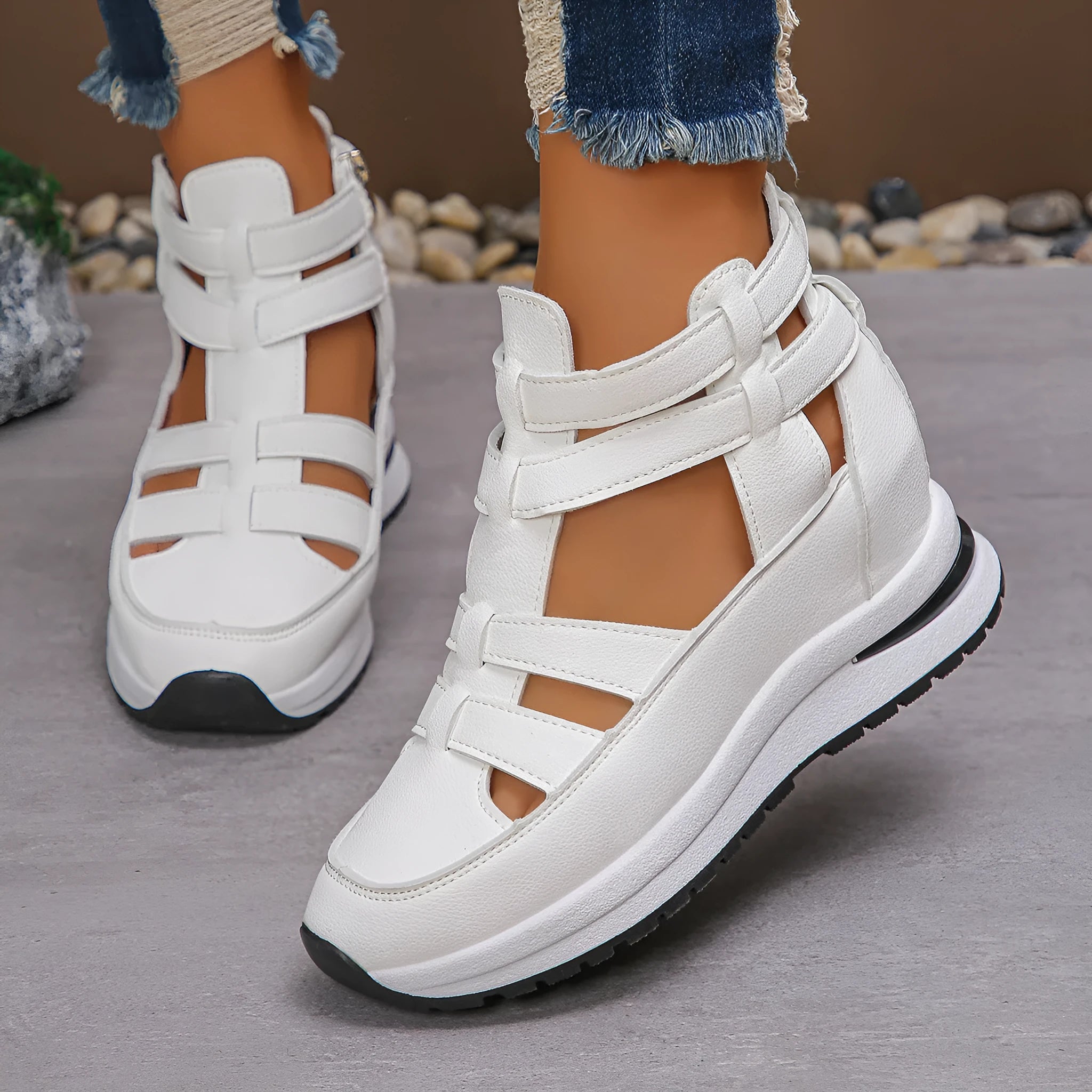 Black women's close-toed hollow-out platform sandals with Velcro strap on a white background