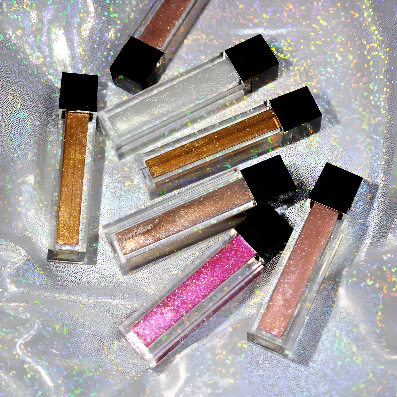 Pearlescent colourful lip gloss tube with shiny waterproof formula in five shades