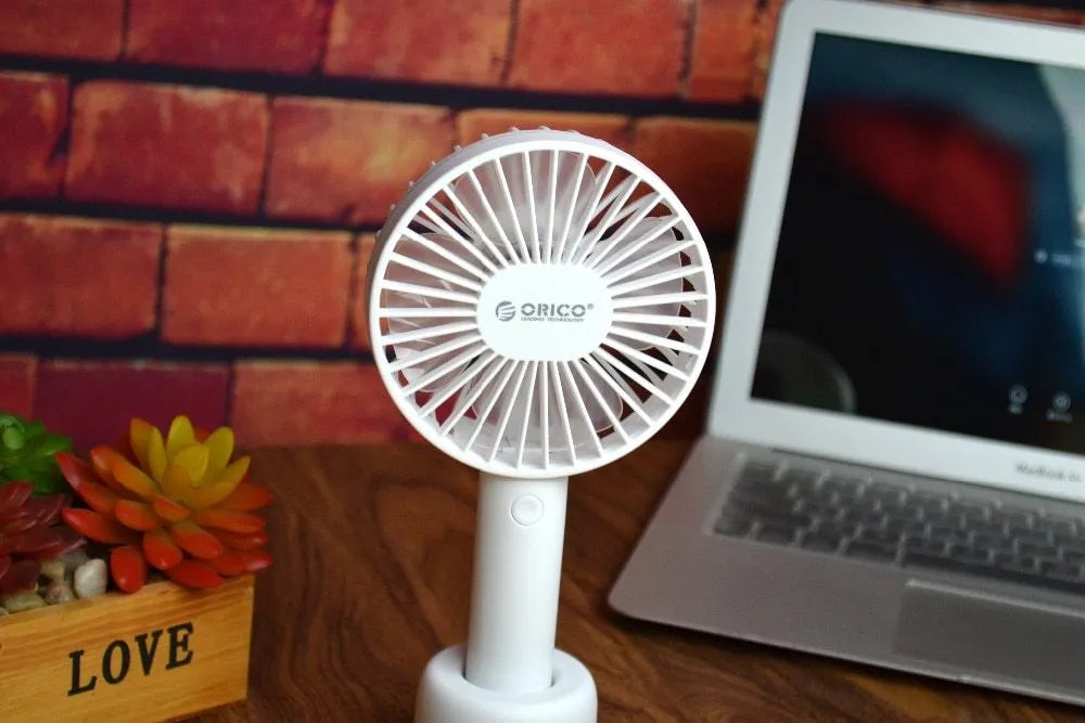 White ORICO FH1 rechargeable USB desktop and handheld fan showing fine line details on its ABS shell.