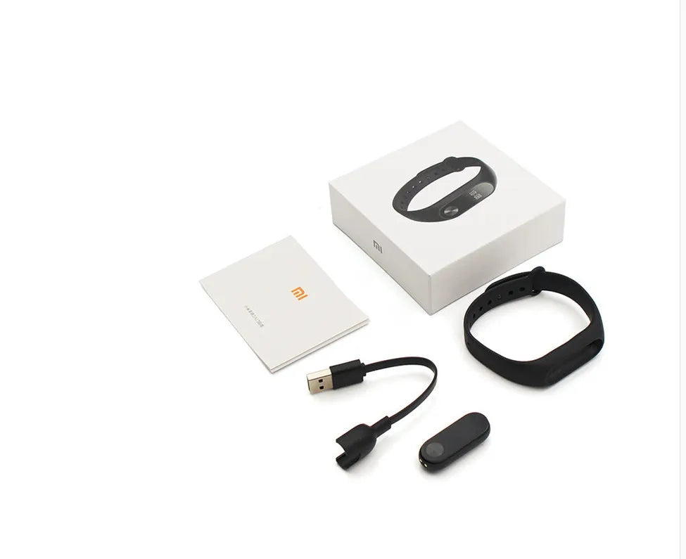 Xiaomi Mi Band 2 black fitness tracker on wrist showing OLED screen display.