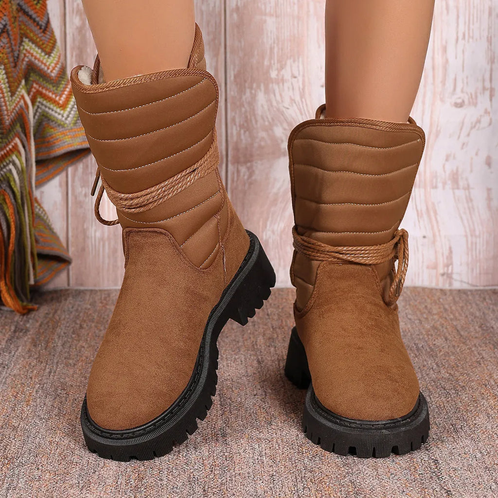 Women's black suede snow boots with chunky heel, fleece lining, and lace-up design.
