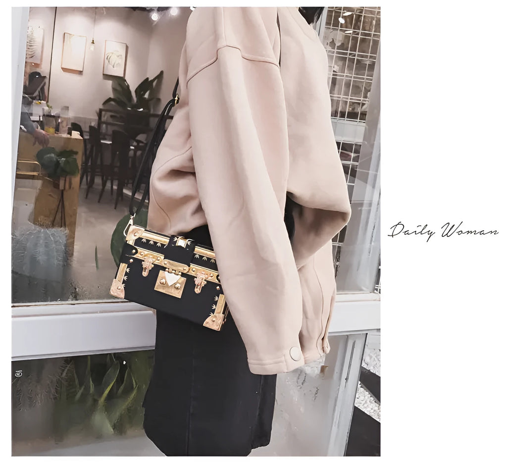 Hard black PU leather women's crossbody flap bag with metal rivet detail and hasp closure.