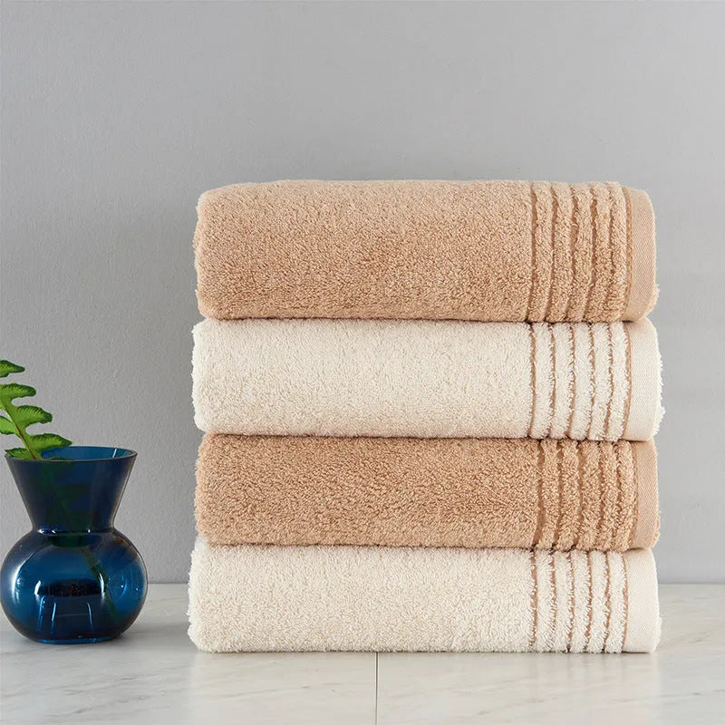Cotton towel set showing three sizes in beige and brown colours for bathroom use