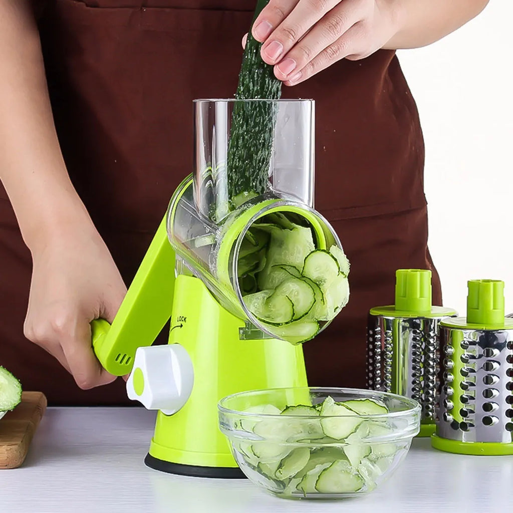 Blue green mandoline vegetable slicer with suction cup base and three stainless steel blades.