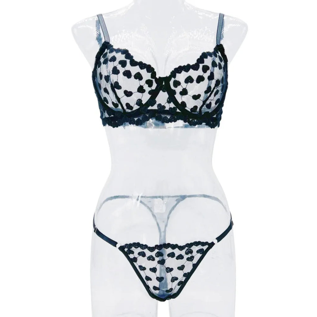 Women's red mesh two-piece suit set with top and trousers on a hanger.