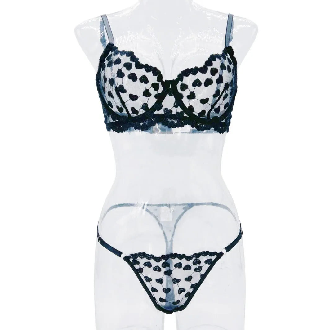 Women's red mesh two-piece suit set with top and trousers on a hanger.