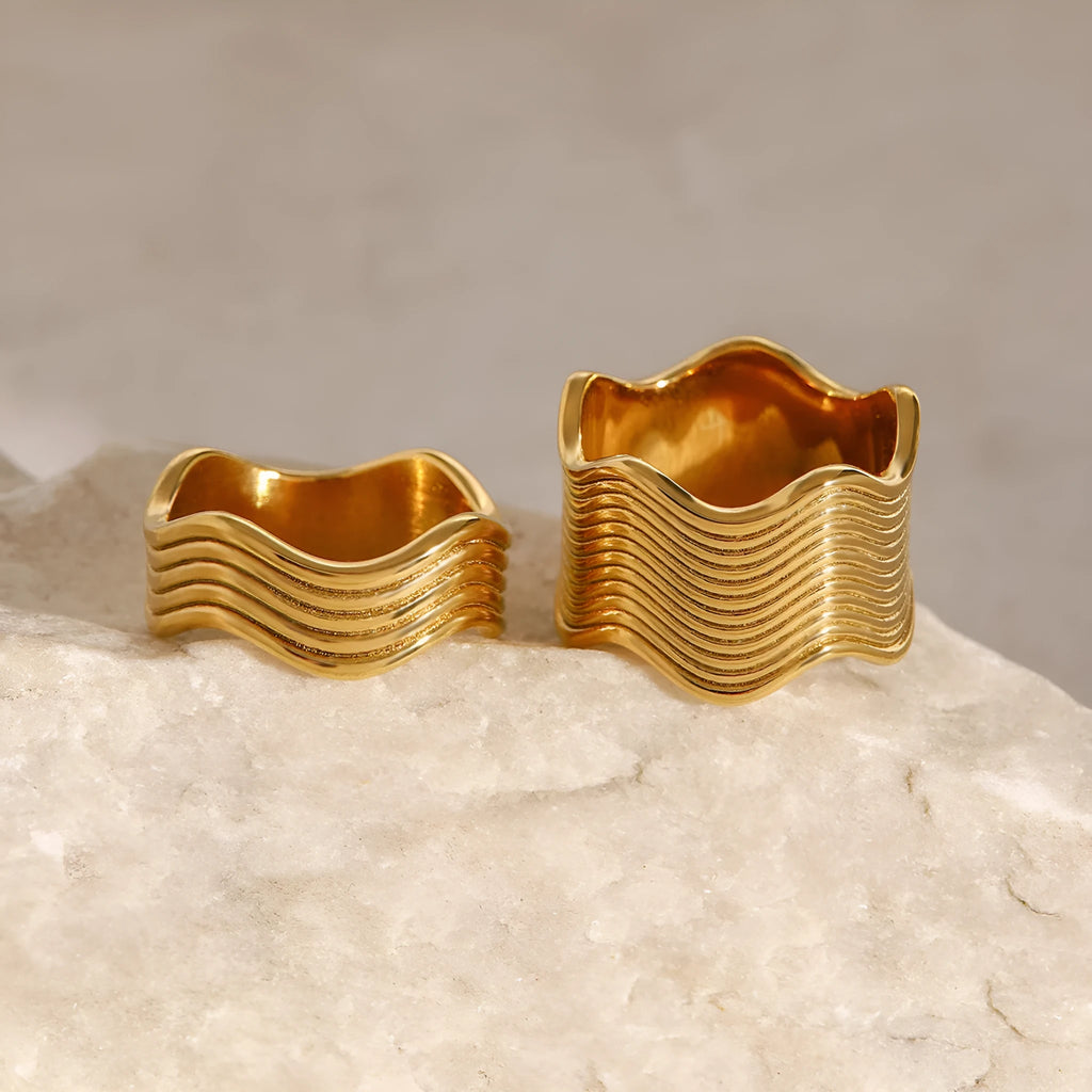 Stainless steel geometric wave ring for women in silver or gold finish.