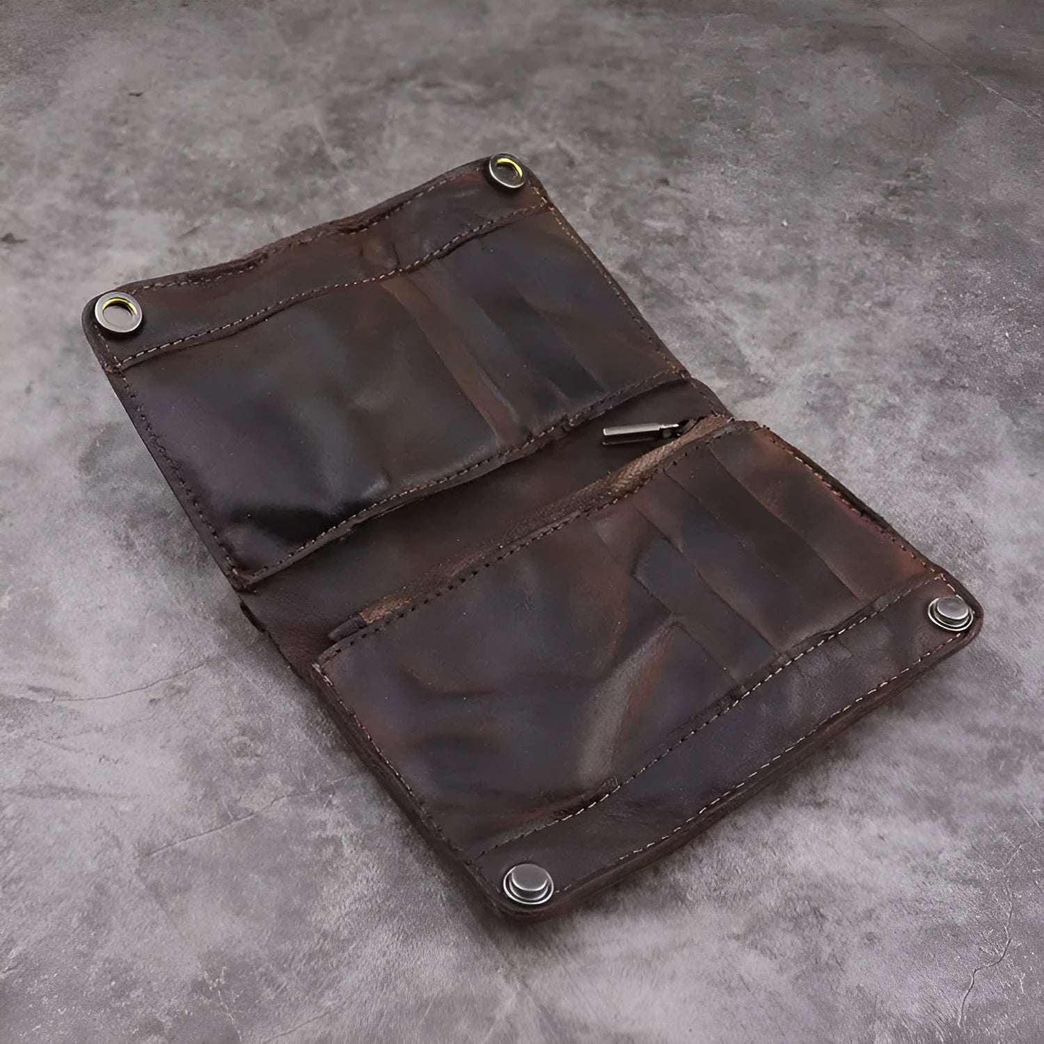 Men's brown leather bifold wallet open showing multiple card slots and coin pocket
