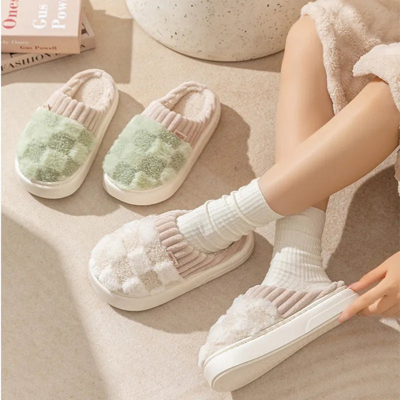 Women's plaid plush slippers in coffee colour with a soft upper, plush lining, and textured PVC sole.