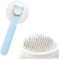 Self-cleaning cat brush with blue handle and rubber-tipped metal pins