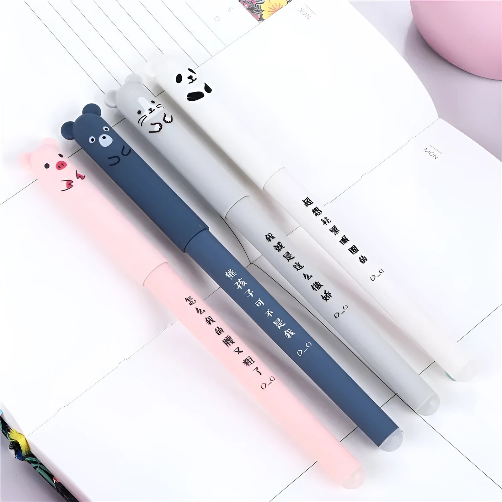 A black heat-erasable pen with a 0.5mm tip, shown with spare refill nibs and caps.