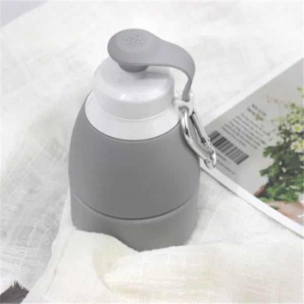 Blue silicone folding water bottle shown at full height and collapsed height next to a backpack