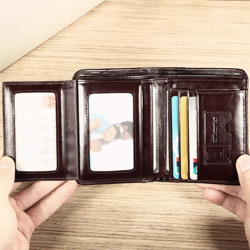 Men's black leather wallet open, showing internal card slots, photo slot, change pocket and hidden compartment.